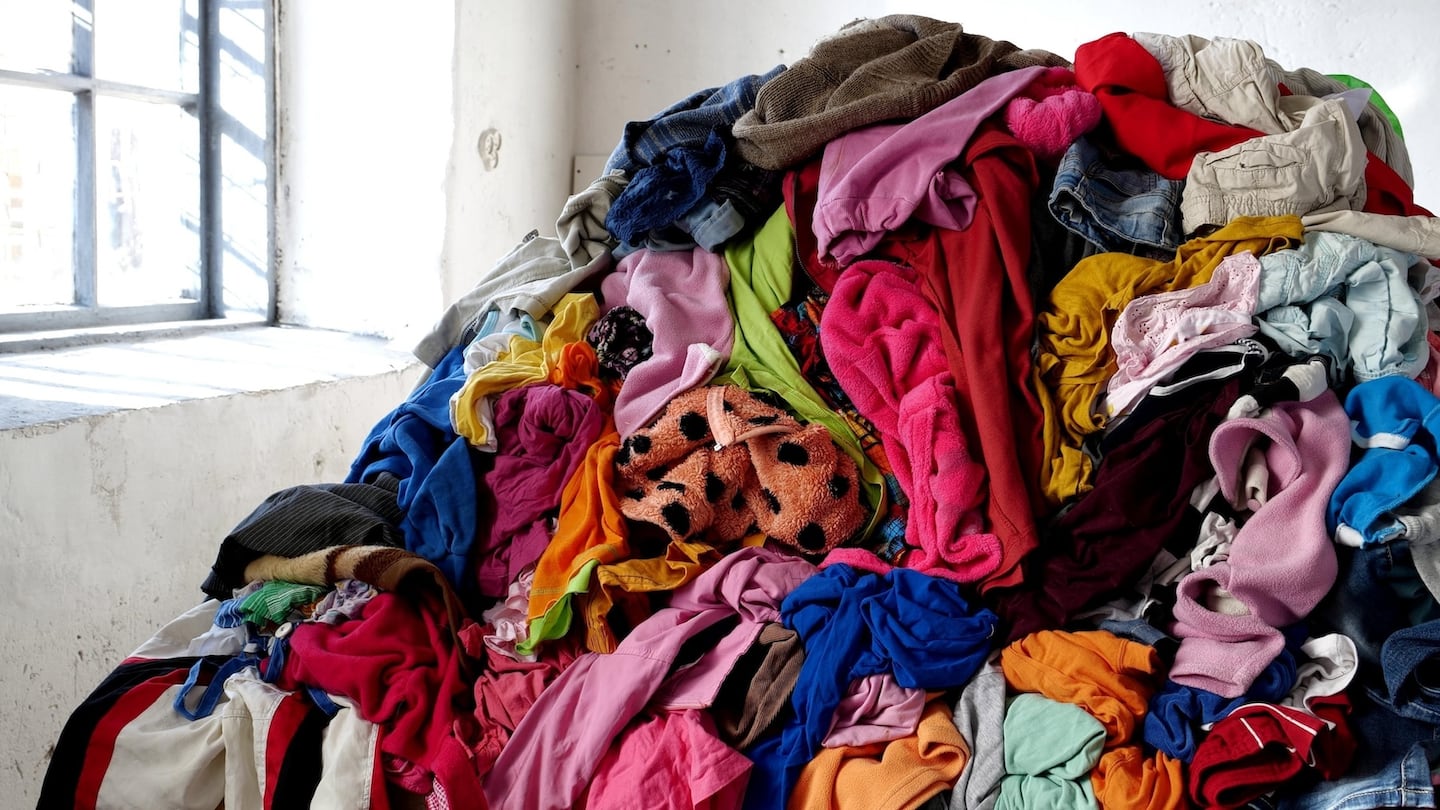 A pile of clothes sits in a warehouse.