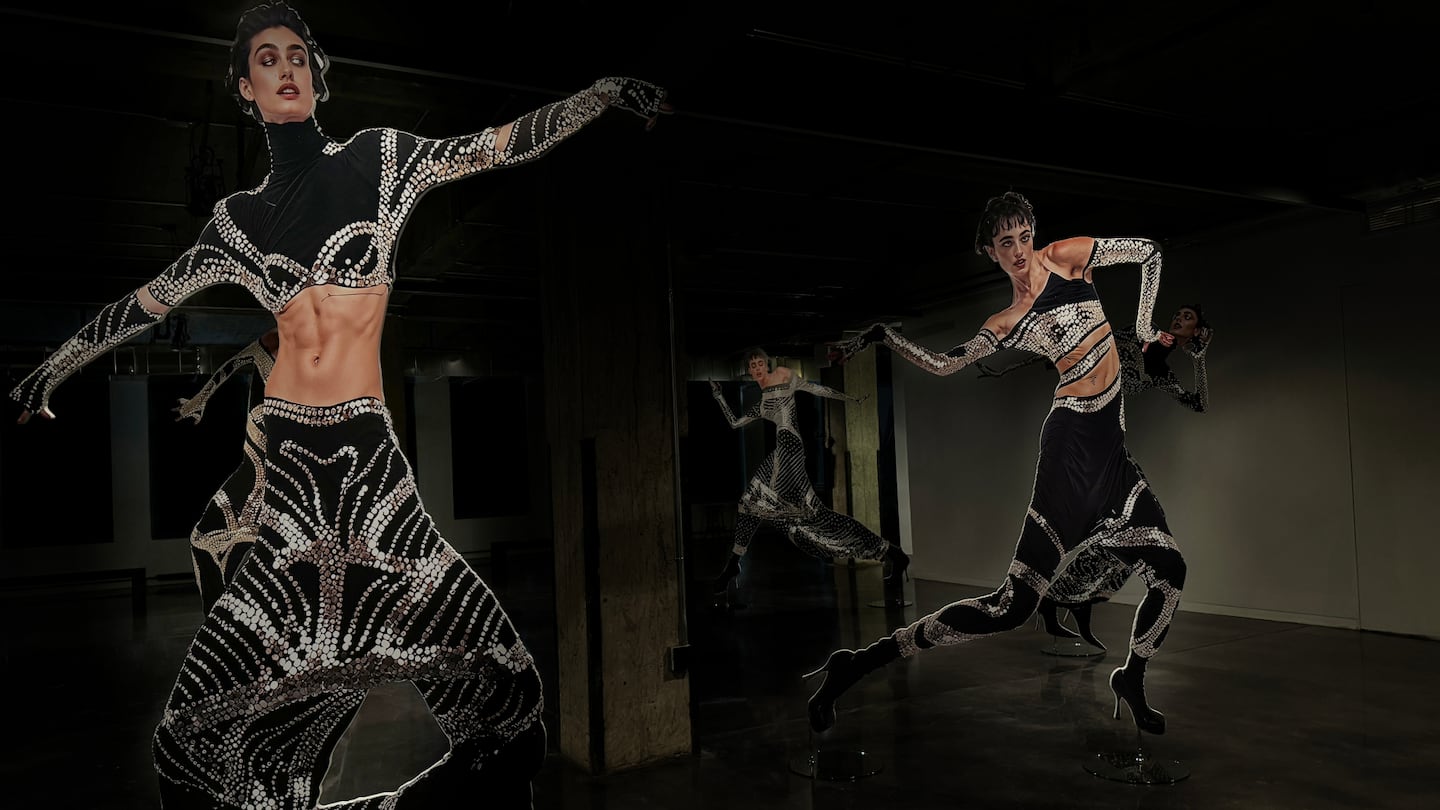 Eight-foot cutouts of slightly stretched-looking models frozen in motion are positioned around an industrial room.